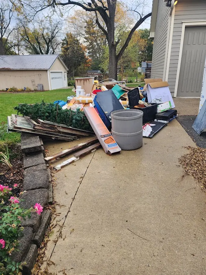 Dumpster being loaded with debris for 12 Yard Dumpster Rental in Biddeford